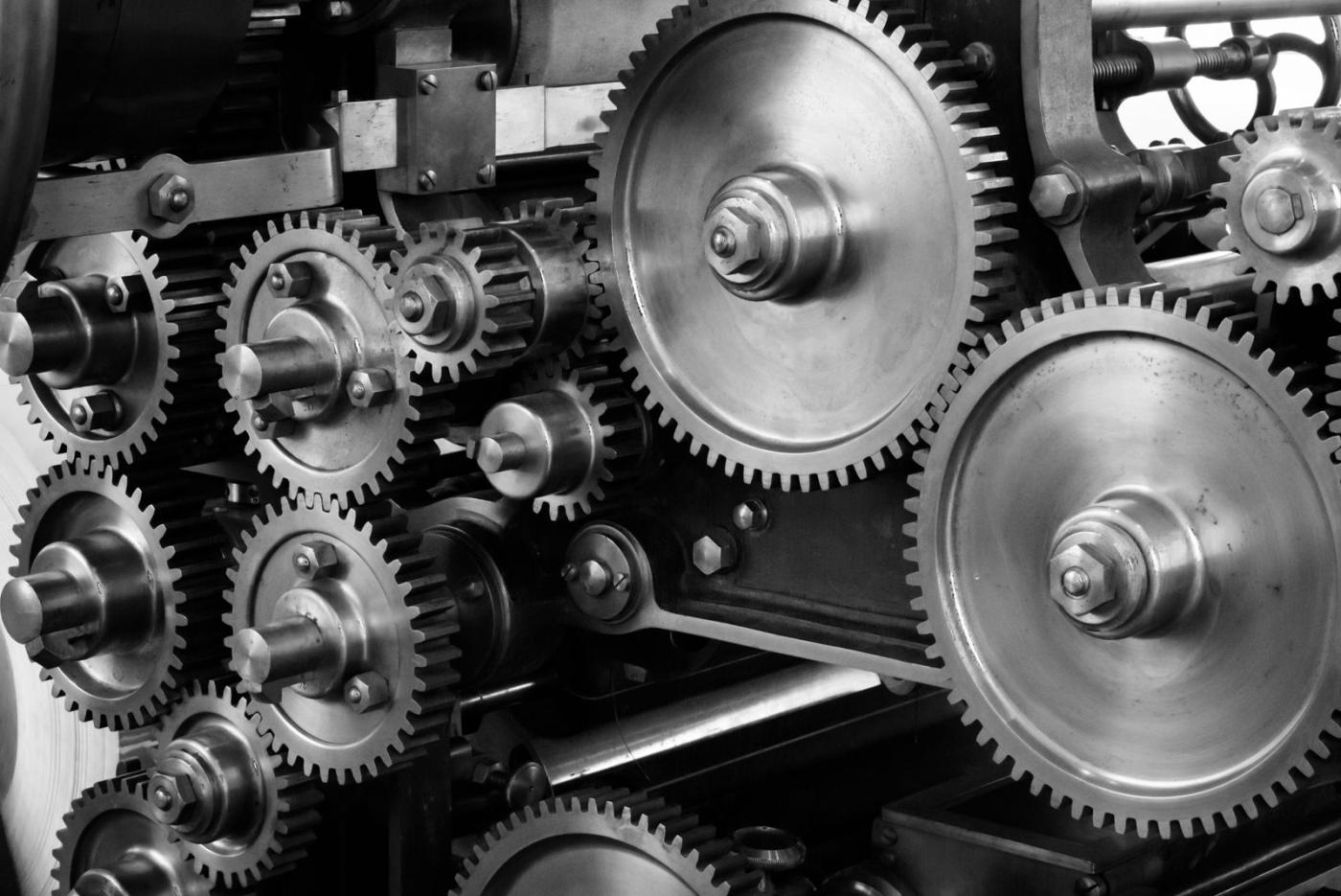 Interlocking metal gears inside a machine.