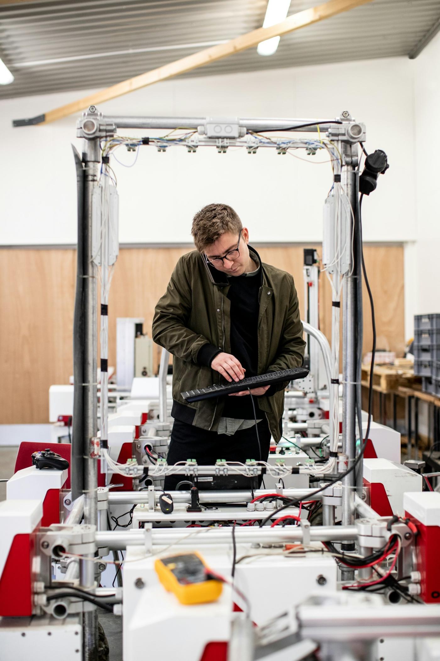 A technician setting a machine from a keyboard on the line.